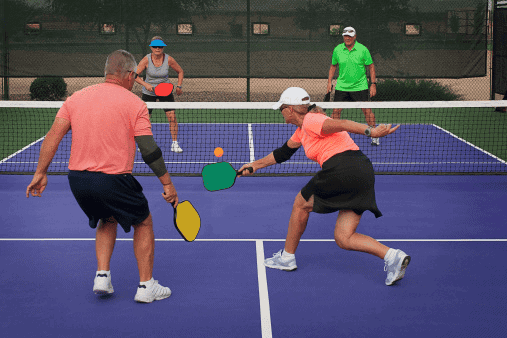 Two pickleball players playing singles on a court